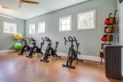 Thumbnail 33 of 48 - exercise bikes in the exercise room at the shiloh green apartments in kennesaw,
