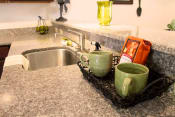 Thumbnail 22 of 36 - a kitchen counter with coffee cups and a sink at Chester Village Green Apartments, Virginia
