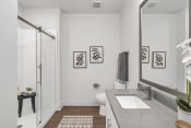 Thumbnail 9 of 41 - a bathroom with white walls and gray countertops