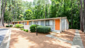 Thumbnail 4 of 28 - a manufactured home in a wooded area