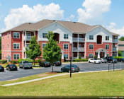 Thumbnail 5 of 47 - Parking lot with grenery at the Haven at Reed Creek apartments Martinez, GA