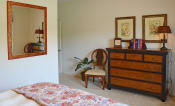 Thumbnail 20 of 25 - Spacious bedroom with dressor and mirror at the Haven at Market Street Station Johnson City, TN