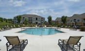 Thumbnail 10 of 25 - Spacious pool with comfortable lounge chairs at the Haven at Market Street Station Johnson City, TN