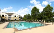 Thumbnail 16 of 47 - Sparkling pool with sundeck and lounge chairs at the Haven at Reed Creek Apartments Martinez, GA