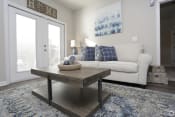 Thumbnail 10 of 31 - Model apartment with couch and coffee table at Highborne Augusta, GA