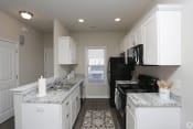 Thumbnail 12 of 31 - Spacious kitchen with white cabinets at Highborne apartments Augusta, GA
