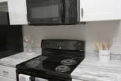 Thumbnail 11 of 31 - Kitchen at HIghborne apartments with black appliances Augusta, GA