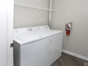 Thumbnail 10 of 25 - a washer and dryer in a room with a fire hydrant