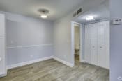 Thumbnail 5 of 16 - an empty room with white closet doors and a hallway to a bathroom at Beach Club, Tampa, 33614