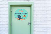 Thumbnail 30 of 34 - a green door with a sign that says the oasis fitness center