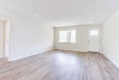 Thumbnail 15 of 34 - a bedroom with hardwood floors and white walls