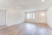 Thumbnail 22 of 34 - a bedroom with hardwood floors and white walls