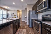Thumbnail 5 of 33 - a kitchen with dark cabinets and stainless steel appliances at Park 33, Goshen Indiana