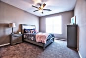 Thumbnail 11 of 33 - a bedroom with a bed and a ceiling fan at Park 33, Goshen Indiana
