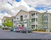 Thumbnail 4 of 25 - Exterior image of parking lot and apartments at the Haven at Market Street Station Johnson City, TN