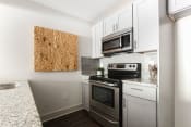 Thumbnail 2 of 29 - Chef-Inspired Kitchens Feature Stainless Steel Appliances at The Metro Apartments, Atlanta