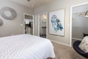 Thumbnail 11 of 40 - a bedroom with a white bed and a painting of an owl at Ansley at Town Center in Evans GA