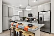 Thumbnail 6 of 39 - a kitchen with stainless steel appliances and a marble counter top