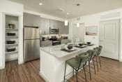 Thumbnail 1 of 42 - a kitchen with a large island and stainless steel appliances