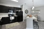 Thumbnail 2 of 35 - a kitchen with black appliances and a marble counter top
