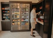 Thumbnail 31 of 39 - a man standing in front of a refrigerator