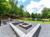 Thumbnail 24 of 33 - Gathering Area With Grills And Corn Hole at St. Andrews Apartment Homes, Johns Creek