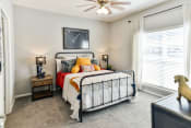 Thumbnail 5 of 25 - Secondary bedroom with ceiling fan and large window at Grand Island Apartments in Memphis TN 38103