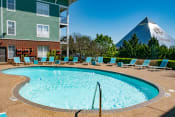 Thumbnail 15 of 25 - Pool and sundeck overlooking pyramid at Grand Island Apartments in Memphis TN 38103