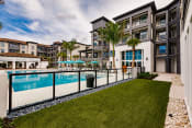 Thumbnail 15 of 18 - Side yard at the pool at Harrison Apartments, Florida, 34243