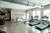 Thumbnail 7 of 11 - a gym with treadmills and other exercise equipment