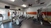 Thumbnail 6 of 17 - a gym with exercise equipment and windows