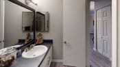 Thumbnail 4 of 17 - a bathroom with a sink and a mirror