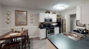 Thumbnail 1 of 17 - a kitchen with white cabinetry and black appliances