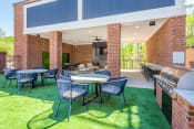 Thumbnail 6 of 31 - a patio with tables and chairs and a grill at The Livano Tryon, Charlotte, North Carolina