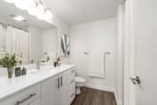 Thumbnail 13 of 34 - Bathroom with white cabinetry and white countertop