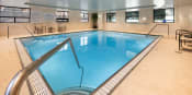 Thumbnail 25 of 34 - Indoor swimming pool with windows and seating areas