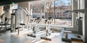 Thumbnail 19 of 34 - Fitness center with large window view of nearby buildings