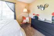 Thumbnail 8 of 29 - a bedroom with a bed and a dresser  at Riverset Apartments, Memphis