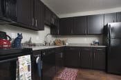 Thumbnail 1 of 19 - Kitchen with Black Appliances at The Pointe at St. Joseph Apartments, South Bend, Indiana