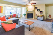Thumbnail 2 of 29 - a living room with a fireplace and a ceiling fan  at Riverset Apartments, Tennessee