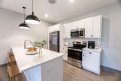 Thumbnail 2 of 52 - a kitchen with white cabinets and stainless steel appliances at The Commons at Rivertown, Grandville, MI