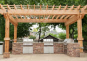 Thumbnail 28 of 29 - an outdoor kitchen with a pergola and barbecue  at Riverset Apartments, Tennessee, 38103