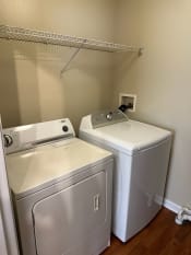 Thumbnail 14 of 23 - a laundry room with a washer and dryer