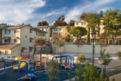 Thumbnail 1 of 16 - Playground and apartment buildings at Mission Plaza Apartments, Los Angeles, CA