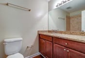 Thumbnail 3 of 24 - Bathroom with a toilet sink and mirror at River Crossing Apartments, Georgia