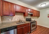 Thumbnail 1 of 24 - Kitchen with stainless steel appliances at River Crossing Apartments, Georgia