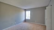 Thumbnail 14 of 24 - Spacious Bedroom with Carpeting at River Crossing Apartments, Thunderbolt