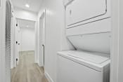 Thumbnail 20 of 23 - the laundry room of a home with white cabinets and a washer and dryer