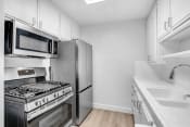 Thumbnail 21 of 48 - a kitchen with stainless steel appliances and white cabinets