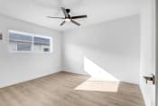 Thumbnail 31 of 48 - an empty room with white walls and a ceiling fan